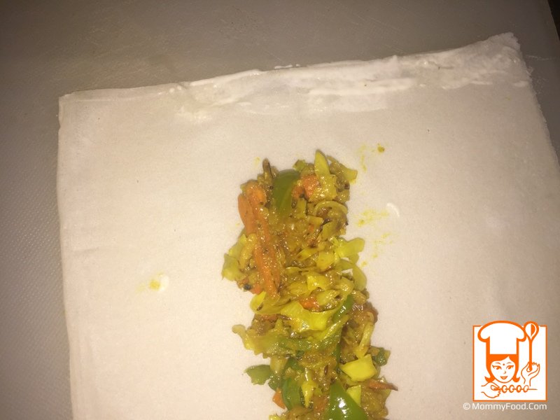 Applying maida paste to the edges