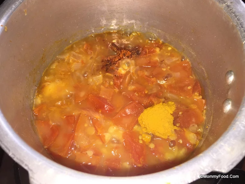 Simmering cooked dal with spices
