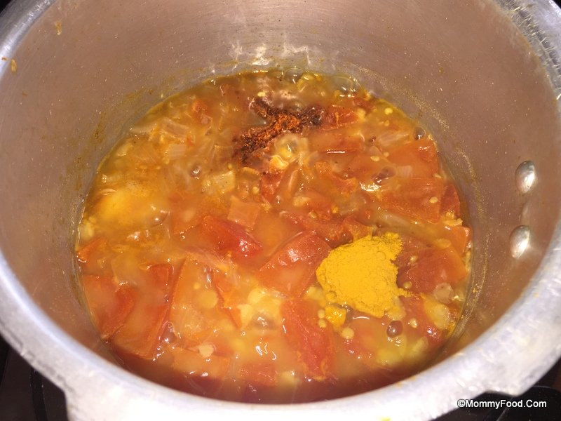 Simmering cooked dal with spices