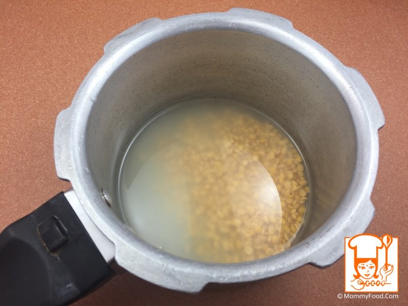 Adding washed toor dal to pressure cooker