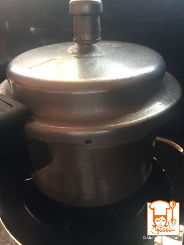 Pressure cooker on stove cooking the mixture