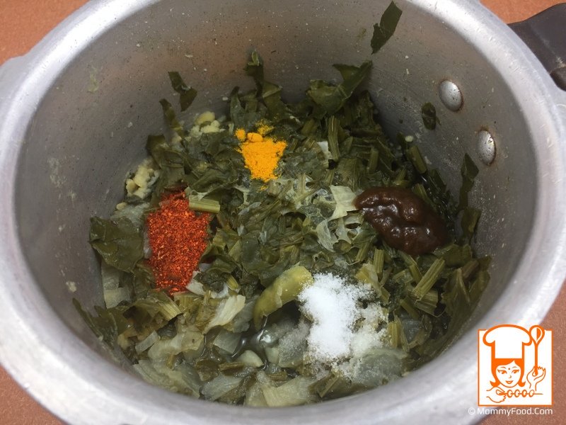 Adding spices and tamarind paste to the cooked mixture