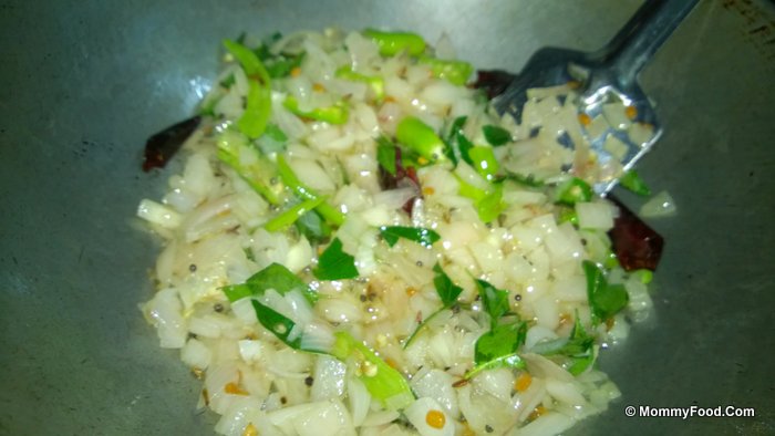 Adding curry leaves and turmeric to the pan