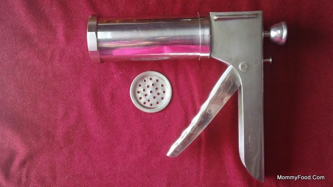 A traditional cooking tool for making Kaaram Poosa