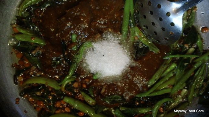 Adding tamarind paste and seasoning to the spices