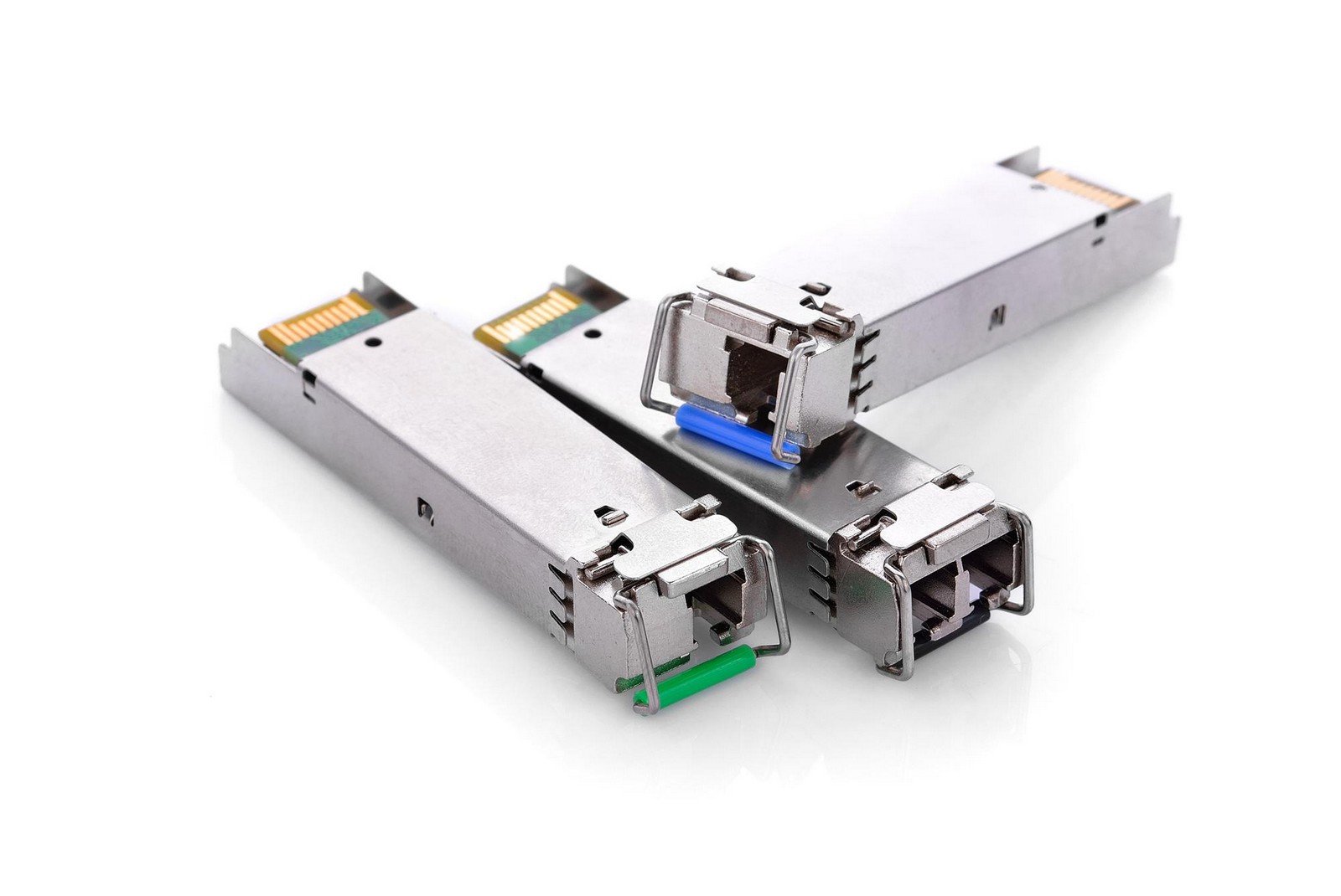 Close-up of three SFP transceiver modules, showcasing compact design and connectors, used for high-speed networking and data transmission in telecommunications.